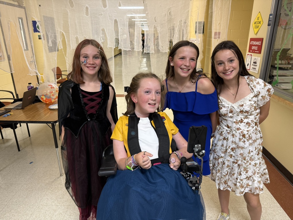 Bella at school smiling with three of her friends